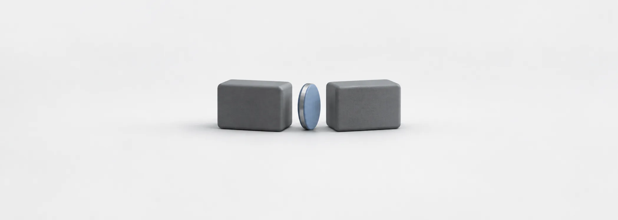 A steel-blue coin stands in the gap between two graphite blocks, representing the distance between bid and ask.