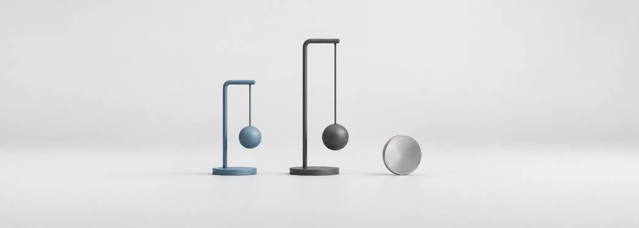A short steel-blue pendulum, a long graphite pendulum and a silver coin symbolize different sensitivities to changing rates.