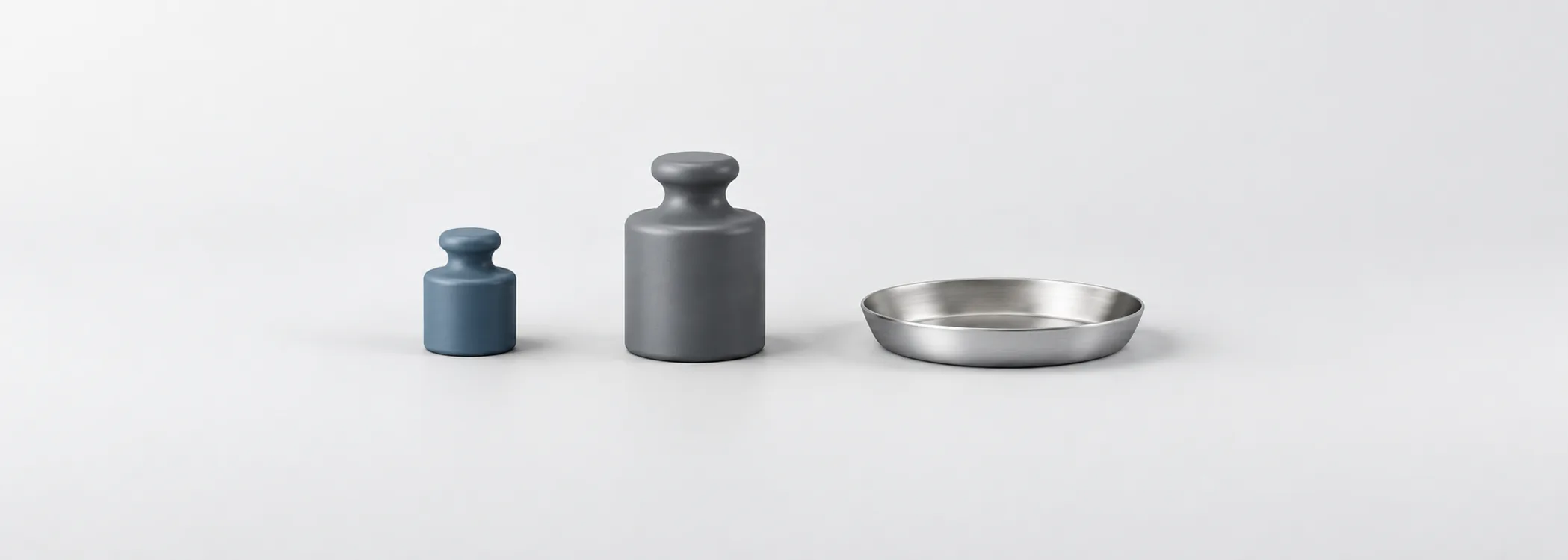 Small steel-blue and large graphite weights beside a silver balance tray, representing different amounts at risk.