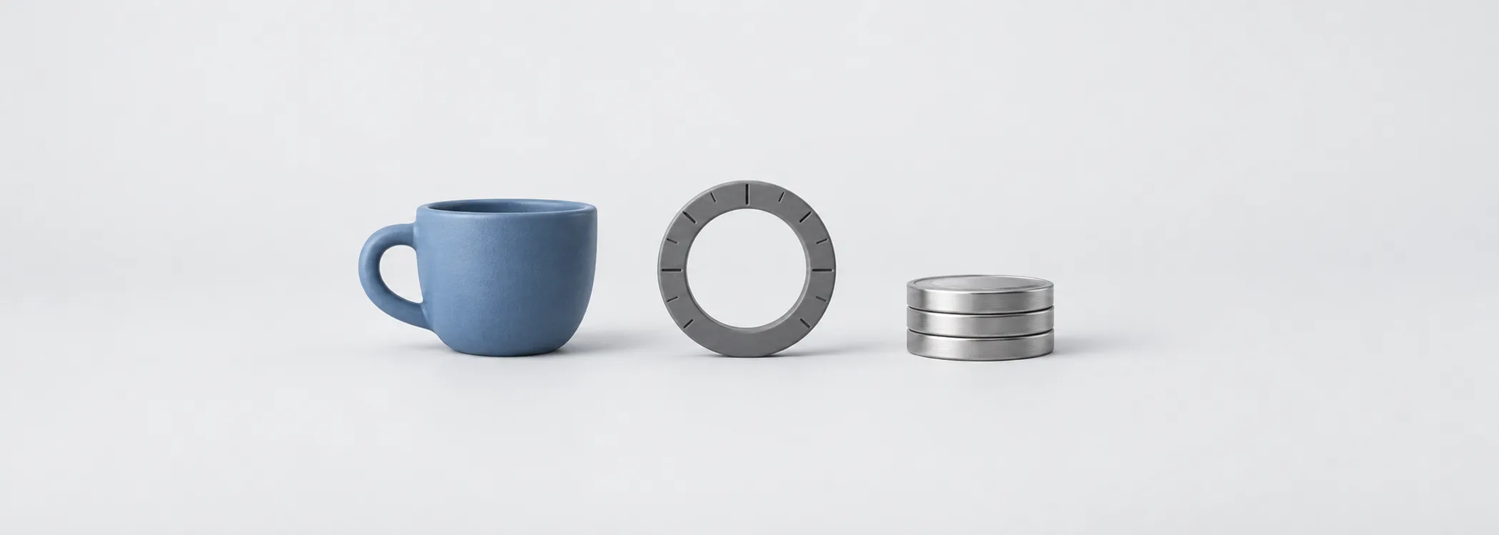 A steel-blue coffee cup, graphite measuring ring and silver coins symbolize measuring profit against owners' capital.